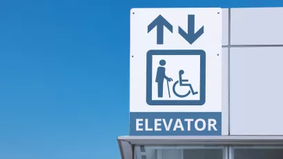 Close-up of subway station elevator sign.