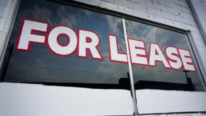 For Lease painted on window of vacant commercial space.