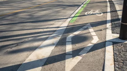Painted bike lane with bike symbol and diamond on street in downtown Toronto, Ontario.