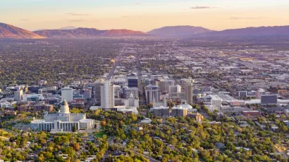 Aerial view of Salt Lake City, Utah with capitol dome in foreground again sunset sky.