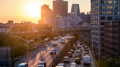 New York City traffic on elevated highway at sunset.