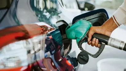 Close-up of hand filling car with gas at gas pump