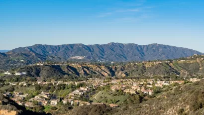 Homes in Altadena, California with mountains in background on a sunny day.