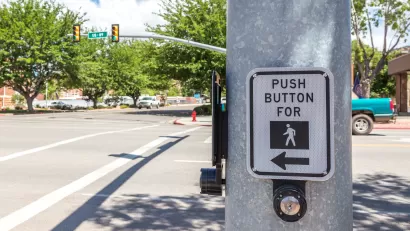 CLose-up of pedestrian call button on pole at intersection
