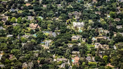 Aerial view of large houses in large yards surrounded by trees in Palo Alto, California