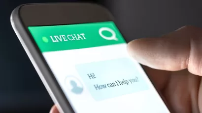 View of a phone with a chatbot interface asking user how it can help them.