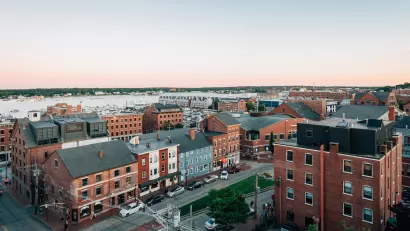 Aerial view of mid-rise brick buildings in Portland, Maine on waterfront.
