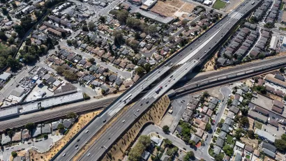 Aerial view of 238 freeway in Oakland, California cutting through neighborhood with small houses