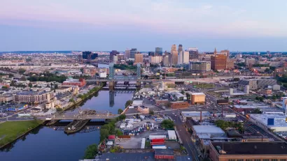 Aerial view of Newwark, New Jersey at sunset with river in foreground.