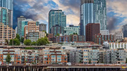 View of dense apartment buildings on Seattle waterfront with high-rise buildings in background.