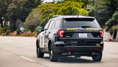 View from back of BART Police SUV driving down street in San Francisco, California.