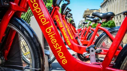 Close-up of red Capital Bikeshare bikes parked at statio on sidewalk in Washington D.C.