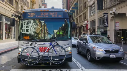 Muni bus with bike on front bike rack on San Francisco street