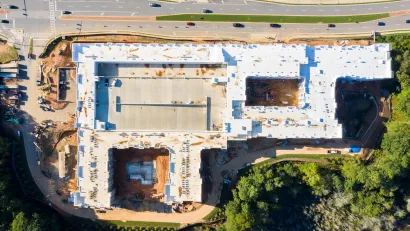 Bird's eye view of large apartment complex under construction next to four-lane road near Atlanta, Georgia.