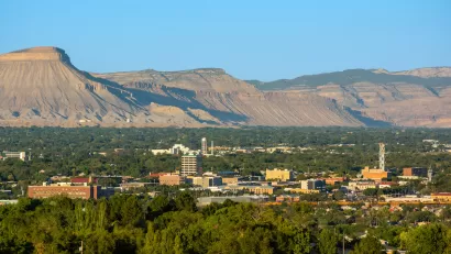 View of downtown Grand Junction, Colorado with mesas in background.