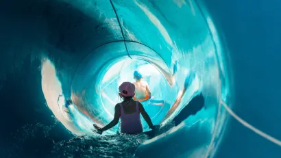 Children inside large slide at water park.