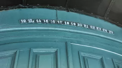 Green wall with floor or apartment numbers missing number 13, goes from 12 to 12 1/3 to 14 instead.