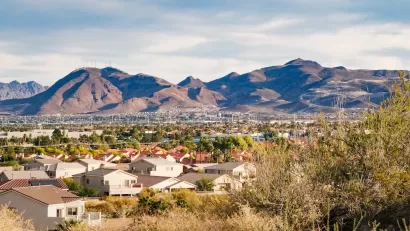 View of large homes in Henderson, Nevada with desert mountains in background.