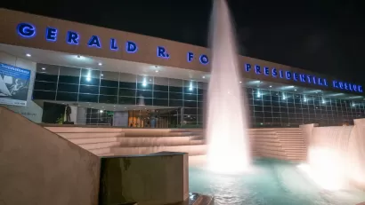 Exterior of Gerald Ford Presidentail Library with fountain at night.
