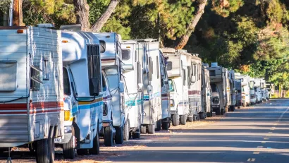 Line of RVs being used as homes parked on street in Mountain View, California.