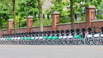 Long row of Bixi bike share bikes parked at station on street in Montreal, Canada.