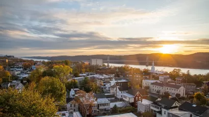 Aerial view of small town in Hudson Valley, New York State with river at sunset.