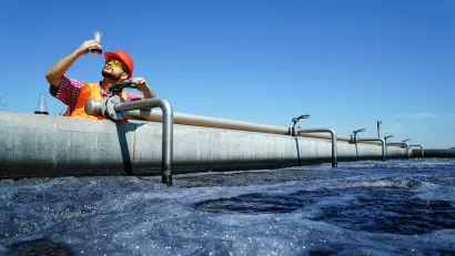 An engineer controlling a quality of water ,aerated activated sludge tank at a waste water treatment plant.