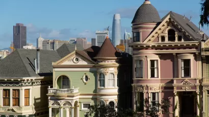 Ornate Victorian San Francisco houses with modern high-rises in background.