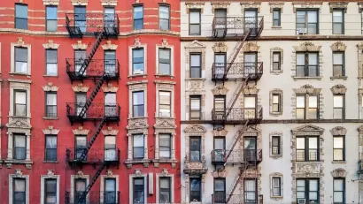 Facade of brick multistory apartment buildings in New York City with fire scapes.