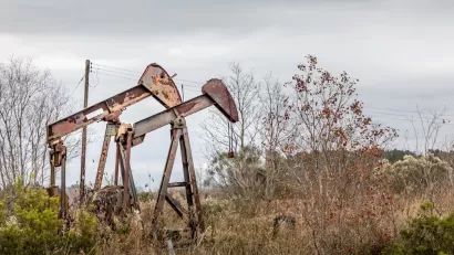 Two rusty, abandoned oil pumps in rural Texas.