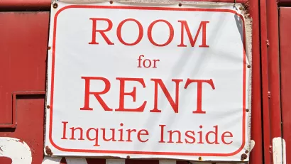 Red on white 'Room for Rent, Inquire Inside' sign
