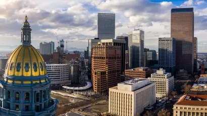 Aerial view of gold state capitol dome in Denver, Colorado and Denver skyline.