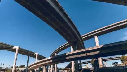 View from under tall Los Angeles freeway overpass.