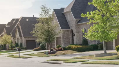 View of brick two-story houses in Dallas suburb