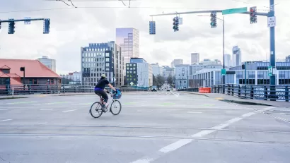 Person on bike in empty intersection in Portland, Oregon.