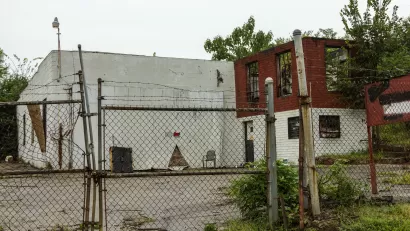 Abandoned, decaying building behind locked chain link fence in Atlanta, Georgia