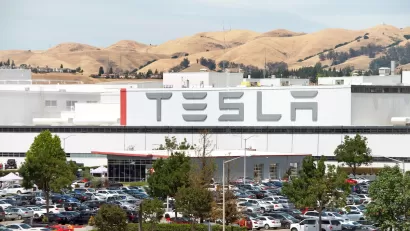 Tesla factory in Fremont, California with dry hills in background.