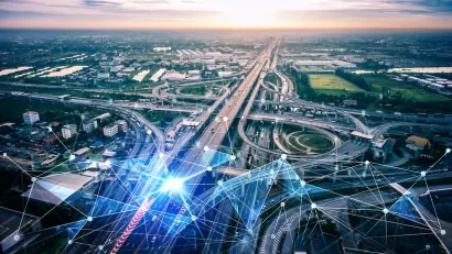AI-generated aerial view of freeway interchange with digital lines overlaid to indicate AI traffic management