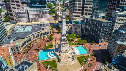 Aerial view of Monument Circle with tall statue on post in middle of traffic circle area in Indianapolis, Indiana