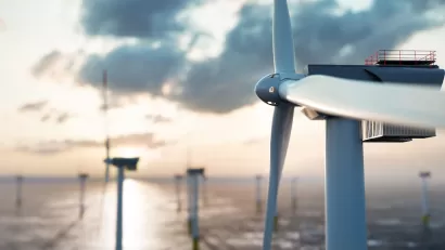 Close-up of offshore wind turbine with other turbines in background.