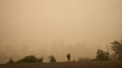 Hazy sky with Portland, Oregon skyline barely visible in background. Man walking in foreground.