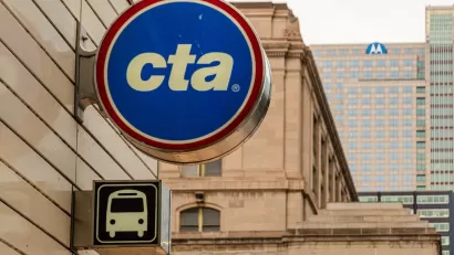 Close-up of round blue, white, and red Chigato Transit Authority "cta" logo on exterior of building.