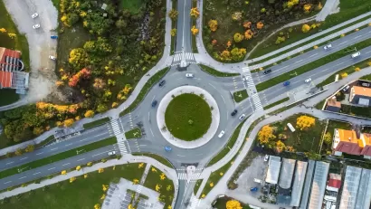 Bird's eye view of roundabout with two lanes and four branches.