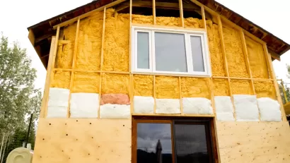 Two-story home being retrofitted with energy-saving insulation.