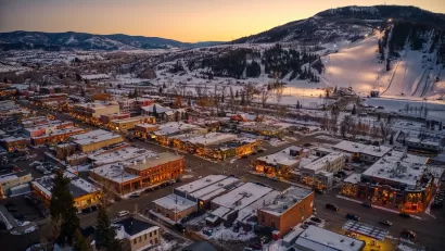 Aerial view of mountain town of Steamboat Springs, Colorado in the winter with snow at dusk.