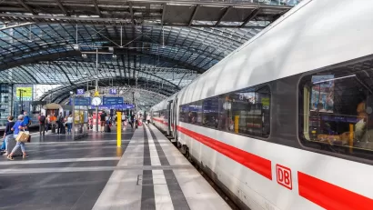 White and red DM high-speed rail train at platform in large train station in Berlin, Germany.