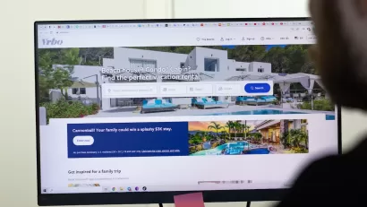 Close-up of computer screen with VRBO short-term rental platform site open.