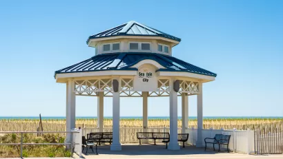 White gazebo with blue roof next to beach in Sea Isle City, New Jersey.