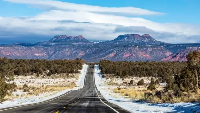 Asphalt road heading toward Bears Ears National Monument in Utah in winter.