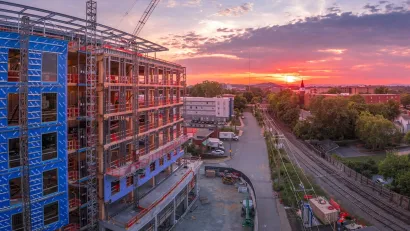 Large building under construnction in downtown Charlottesville, Virginia at sunset.